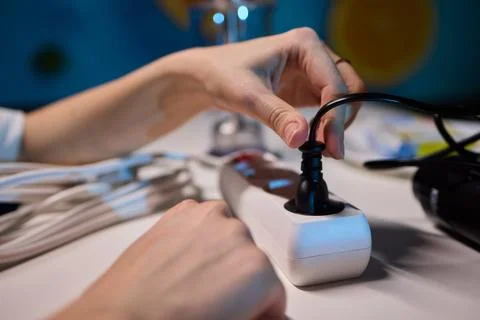 Safe plug connection demonstration, Careful connection of electrical device to Stock Photos