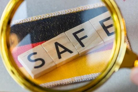 SAFE Program Review Concept with German Flag Under Magnifying Glass 写真素材