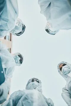 Safe, secure and covered group of healthcare workers wearing masks and hazmat Stock Photos