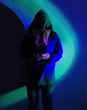 Safe storage of personal data on a smartphone. Shrouded in darkness hooded fi Stock Photos