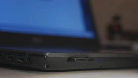 Safely remove hardware. A man's hand extracts a SD card with information from a Stock Footage 145984637