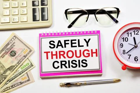 Safely through crisis. A text label in the planning notebook. Stock Photos
