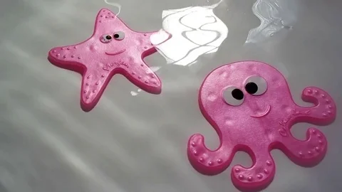 Safety antislip funny rubber starfish and octopus bath or shower Stock Footage