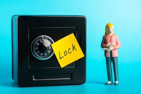 Safety concept: secure lock safe with sticky note and female figurine on bl.. Stock Photos
