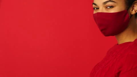 Safety first. Side view of beautiful mixed race girl putting on protective face Stock Footage 146129502