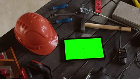 Safety Gear, Tablet and Tools on Table at Active Construction Site Stock Footage 320670671