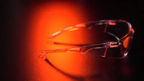Safety glasses on a black Video stock 282511635