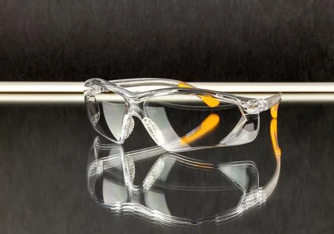 Safety goggles with mirror reflection in the mirror. Stock Photos