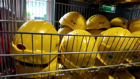 Safety helmets stacked in racks waiting to be used by tourist visiting Guid.. Stock Footage 319408946