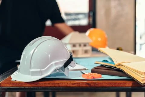 Safety helmets  on the table at site construction. Architect, Engineer and bu Stock Photos