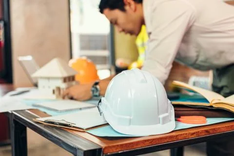 Safety helmets  on the table at site construction. Architect, Engineer and bu Stock Photos
