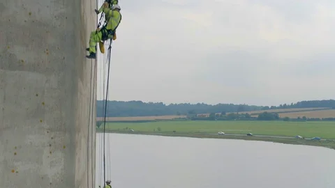 Safety Inspectors Working at Height on a Concrete Bridge Checking for Cracks Stock Footage