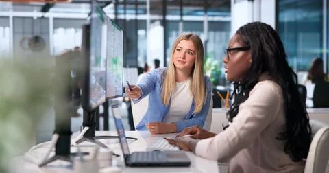 Safety Officer Explains Emergency Exit Routes To Women Using Laptop Diagrams. Stock Photos