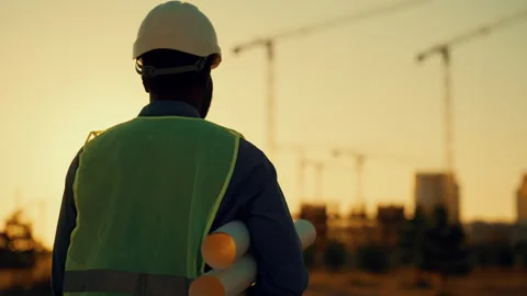 Safety precautions at construction site, back view of builder with white helmet Vídeos de archivo 317806349