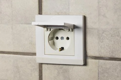 Safety waterproof electricity switch socket with cover in bathroom. Stock Photos