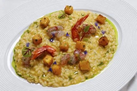 Saffron and pumpkin risotto with red prawns ( gambero rosso) tartare Stock Photos