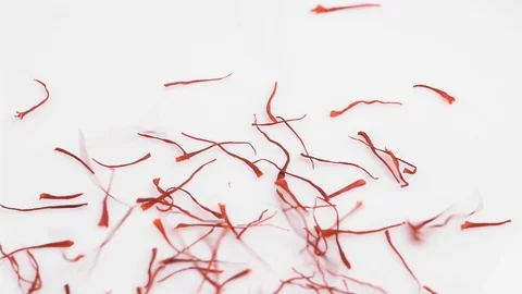 Saffron falling in rotating plate in slow motion Stock Footage 128676189