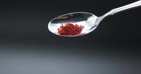 Saffron falling in slow motion from spoon Stock Footage 148960610