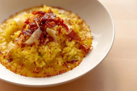 Saffron risotto close up, classic yellow colorful italian food staple dish on Stock Photos