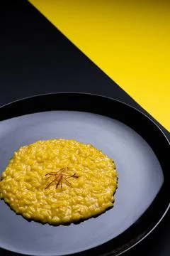 Saffron risotto on dark background Stock Photos