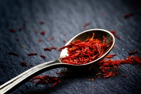 Saffron in a spoon on a dark background, selective focus, macro shot, shallow Stock Photos