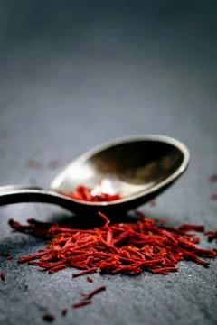 Saffron in a spoon on a dark background, selective focus, macro shot, shallow Stock Photos