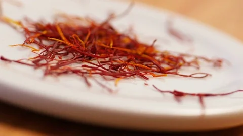 Saffron strands CU, falling on plate Stock Footage 85052943
