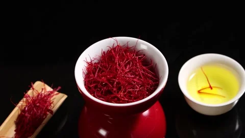 Saffron Threads in Bowl with Herbal Tea on Dark Background Stock Footage 339642184