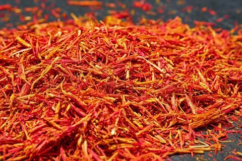 Saffron threads on dark background, close up, selective focus. Aromatic spice Stock Photos