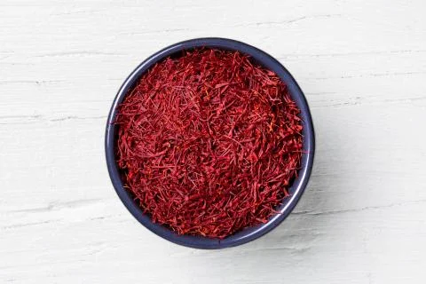 Saffron threads on white wooden background Stock Photos