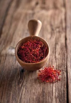 Saffron threads on wooden background Stock Photos