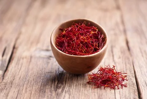 Saffron threads on wooden background Stock Photos