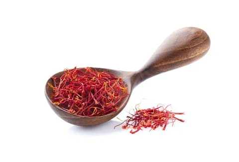 Saffron threads in wooden spoon on white background Stock Photos