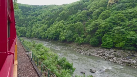 Sagano Romantic Train Running Along Hozugawa River in Kyoto, Japan Stock Footage 329392972