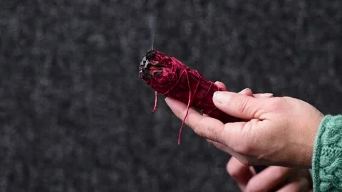 Sage burning close up of hand holding and burning sage ceremony Stock Footage 254590019