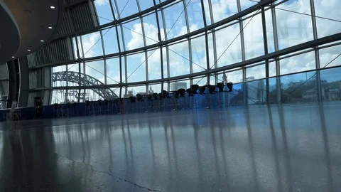 The Sage Gateshead low angle pan revealing Huge Windows and Tyne Bridge Stock Footage 122280225
