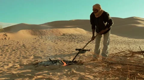 Sahara man preparing ember for bread Video stock 57408702