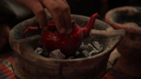 Sahara Morrocan fresh mint tea from a traditional red karraffe Stock Footage 156625405