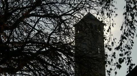 Sahat-kula clock tower seen behind branches in Sarajevo Stock Footage 59856262