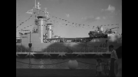 SAIGON - 1957: Dockside visit - Official party walks beneath ship rigging Stock Footage 344502075