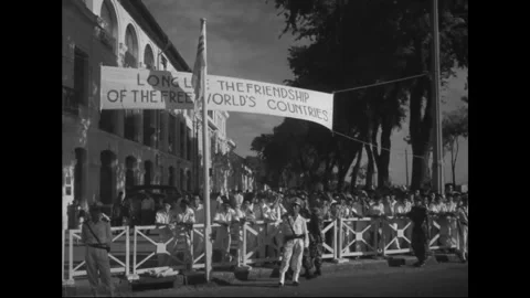 SAIGON - 1957: Street message - Hand-lettered banner spans parade route Stock Footage 344502195