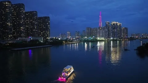 Saigon Skyline and Illuminated Boat on the River at Night Stock Footage 340972902