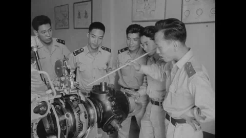 SAIGON, VIETNAM - 1957: Case study session - A pointer rests on an engine case Stock Footage 344004230