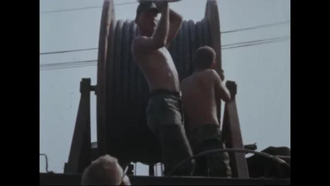 SAIGON, VIETNAM - 1969: Utility Pole Repair - Soldiers work cable reel on truck 库存影片 344001006