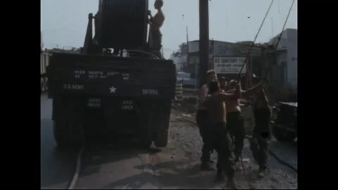 SAIGON, VIETNAM - 1969: Utility Pole Repair - Cable truck parks by storefronts Vidéo 344001045