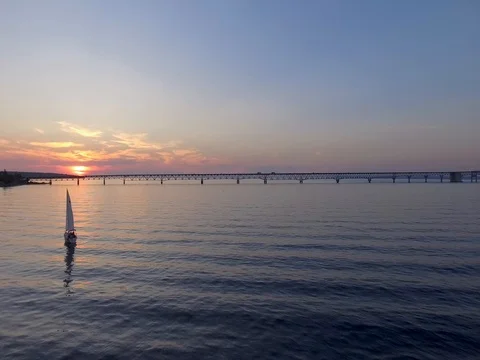 Sail boat watching sunset in front of Mackinac Bridge Stock Footage 80893403