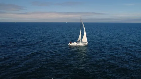  Sail ship moves quickly on waves at sea. Shooting by drone. Vídeo Stock 113647344