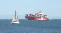 Sailboat and Container Ship In Harbor HD Footage