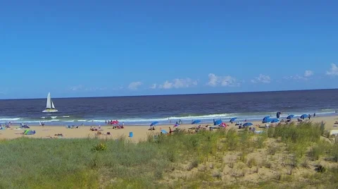 Sailboat and Crowded Beach Stock Footage 59553943