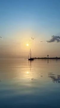 Sailboat and its reflection Stock Photos